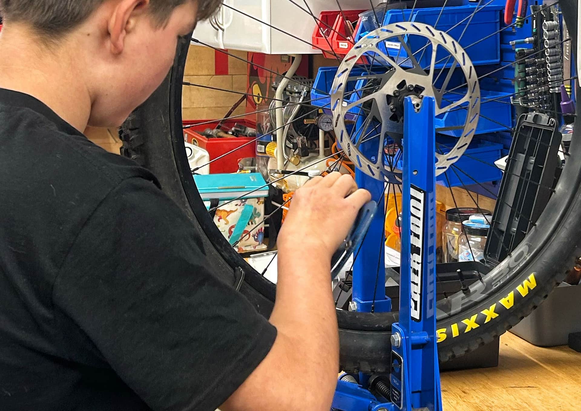 Person carrying out maintenance on a bicycle during platinum course
